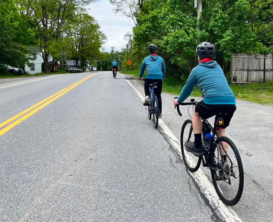 Two Scouts cycling down a quiet road on a 50-mile charity ride