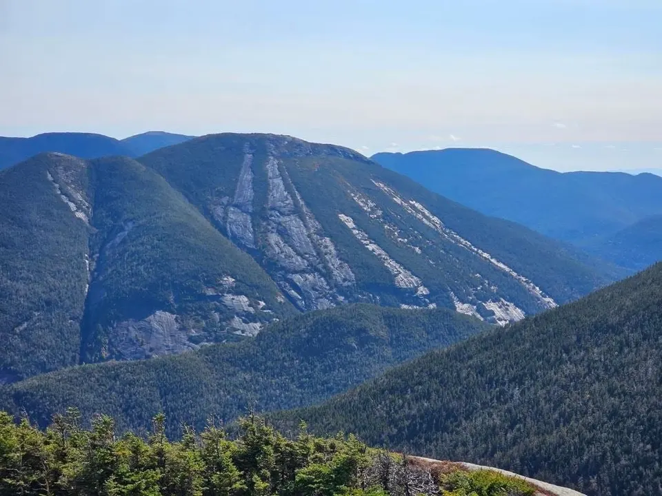 Ridge after ridge of forested Adirondack peaks under a clear sky