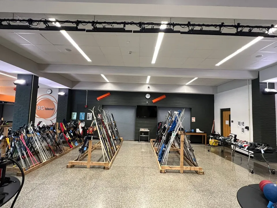 Wooden racks full of downhill and cross-country skis at Sportsmart